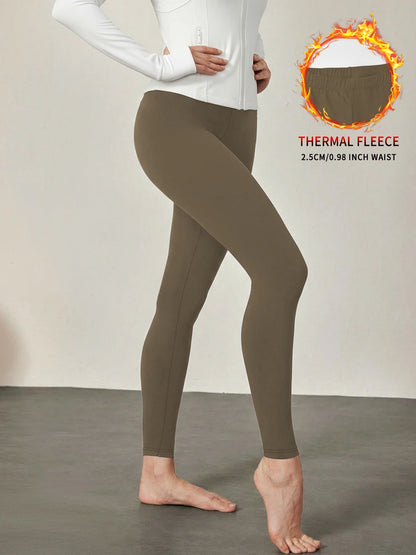 Fleece lined workout leggings with thermal insulation. High waist women's pants ideal for winter running, yoga