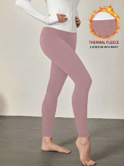 Fleece lined workout leggings with thermal insulation. High waist women's pants ideal for winter running, yoga